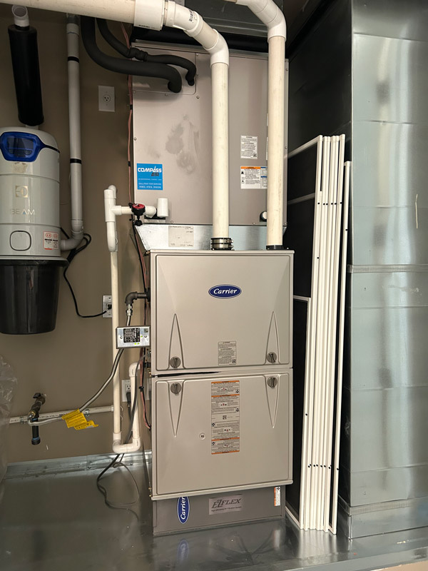 Indoor Carrier HVAC unit inspected during emergency repair in Phoenix, AZ